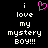 Black background with white pixelated text reading 'i love my mystery boy!!!' and a pink heart symbol above the word 'love'.