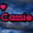 Pixelated text 'Cassie' in bright pink with black outline over blue cloudy background, heart symbol shifts position across frames.