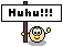 Pixel art of a yellow circular character with black eyes and mouth holding a brown pole with a white sign reading "Huku!!!" in black text, displayed in a of