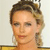 Pixelated close-up of a person with light brown hair styled in an updo, wearing a yellow garment against a light background.