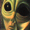 identical stylized alien faces with large black eyes, greenish-yellow skin tones, and subtle facial features arranged in a repeating pattern