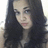 Pixelated static image of a person with long dark hair, light skin tone, and visible facial features including eyes, nose, mouth, and cheeks.