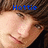 Pixelated close-up of a person's face with blue text reading 'Hottie' overlaid at the top, set against a dark brown background.