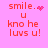 Pixelated pink background with red text reading 'smile. u kno he luvs u!' and animated heart/particle effects replacing punctuation.