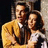 A static image with a red background, featuring two people in an embrace on the left and pixelated text on the right.