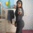 Pixelated static image of a person in dark clothing holding an object, standing before blurred background elements including yellow and green shapes.