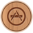 Circular wooden icon with brown border and central symbol resembling stylized 'A' or crossed tools inside concentric rings.