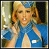 Animated sequence of a person in blue uniform with white accents performing various hand gestures and facial expressions against dark background.