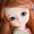 A doll with long brown hair and blue eyes, wearing a light green top with pink trim, shown in four views of changing facial expression.