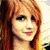 Four distinct views of a person with long red hair in various poses and group settings, displayed as a