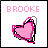 Pixelated icon with pink text 'BROOKE' above a stylized heart shape outlined in black and gray on white background.