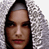 Pixelated static image of a person's face with dark hair and light skin, set against a gray dithered background.
