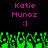 Two identical pixelated text displays with pink 'Katie Munoz' and ':]' above green pixelated grass-like shapes on black background.