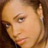 Pixelated close-up of a person's face with light brown hair and neutral expression on a dark background.