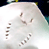A 49x49 pixel animated buddy icon showing a white animal-like figure with brown accents in two sequential frames, displaying subtle pose changes against a dark background.