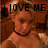 Pixelated image of a person with light brown hair wearing a dark choker necklace, overlaid with bold black text reading 'i LOVE ME' against a warm-toned background.