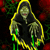 Two side-by-side animated frames of a hooded figure with glowing eyes and green hands against a dark floral background.