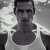 Black-and-white pixelated image of a person in a tank top on left, green background with bright green text 'Original Icons .com' on right.