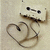 A pixelated icon shows a stylized figure with a mustache and glasses holding a heart-shaped object against a light beige background.