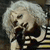 Static pixelated image of a cartoon character with white hair and dark clothing against a gray background.