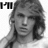 Black-and-white pixelated image of a person with long hair, showing text overlays and a grayed-out section.
