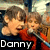 Two children in red and dark blue clothing hold microphones, with text labels and heart symbols changing across frames.