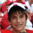 A pixelated image of a person wearing a red and white Santa hat with a black brim, set against a red background with white accents.