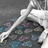 Pixelated image of a white skeletal arm resting on colorful patterned fabric with pink text overlay about best friends and affection.
