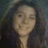 Pixelated static image of a person with dark hair and light skin, wearing a dark top against a muted background.