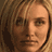 Pixelated static image of a person's face with light brown hair and neutral expression, rendered in low-resolution 256x256 pixels.