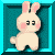 Pixelated bunny with pink cheeks and ears stands in a teal frame, eyes closed as if smiling.