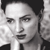 Black-and-white pixelated portrait of a person with short dark hair, neutral expression, and visible facial features including eyes, nose, and mouth.