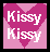 Pixelated pink heart-shaped icon with white text "Kissy Kissy" repeated twice, displayed on a black border against a light gray background.