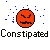 Pixelated orange circular face with angry expression, blue square particles scattered around it on gray background, black text reading 'Constipated' below.