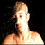 A shirtless person with light hair and a headband appears in four showing slight movement against a dark background