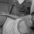 Black-and-white animated icon shows a person in a light-colored sleeveless top holding a long object horizontally, with background elements shifting slightly between frames.
