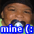 A child in a green shirt and black beanie wears a blue pacifier, with text overlay reading 'mine (:' on the left side.