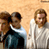 Static 49x49 pixel icon showing three figures in a group pose against a light brown background with visible dithering and low-resolution rendering artifacts.