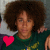 Animated contact sheet showing two frames of a person with curly hair wearing a green shirt, each frame featuring one pink heart symbol in opposite corners.