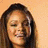 A static image of a person with long dark hair against two-toned backgrounds, left side peach and right side yellow.