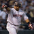 A pixelated image split into two sections: a baseball player in white uniform on the left and a red circular Boston logo with text on the right.