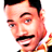 Pixelated static image of a man's face with mustache and dark hair, wearing an orange shirt against white background.