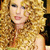 Pixelated image of a person with curly blonde hair on left, adjacent to cyan background with pink pixel-art text reading 'taylor swift fan' on right.
