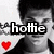 A black-and-white photo of a person with dark hair wearing a dark jacket over a light shirt, with a red heart symbol and the word 'hottie' overlaid on the left side.