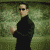 A pixelated figure in black clothing performs sequential hand gestures against a greenish background with visible motion blur.