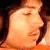 Pixelated close-up of a person's face with closed eyes, dark hair, and warm-toned skin under soft lighting.