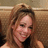 Pixelated static image of a person with light brown hair wearing dark clothing against a neutral-toned background.