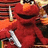 Red puppet-like character with large orange nose and black eyes holds silver sword, background has horizontal stripes and text "You Have Me Suicidal" in white pixelated font.