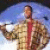Pixelated static image of a person in motion with blurred background, likely from a film or TV scene.
