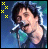 A 7-frame animated contact sheet showing a person singing into a microphone with changing colored pixel clusters around the head against a blue background.